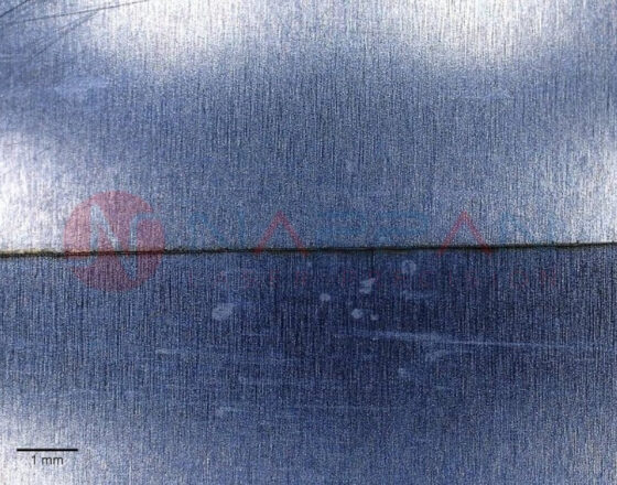 Microscope enhanced image of pulsed fiber laser cut aluminium foil