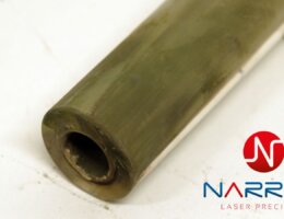 Laser cleaning process removing deposits from glass tubes