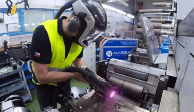 Precision laser cleaning of adhesive-clogged bearing rollers in industrial machinery.